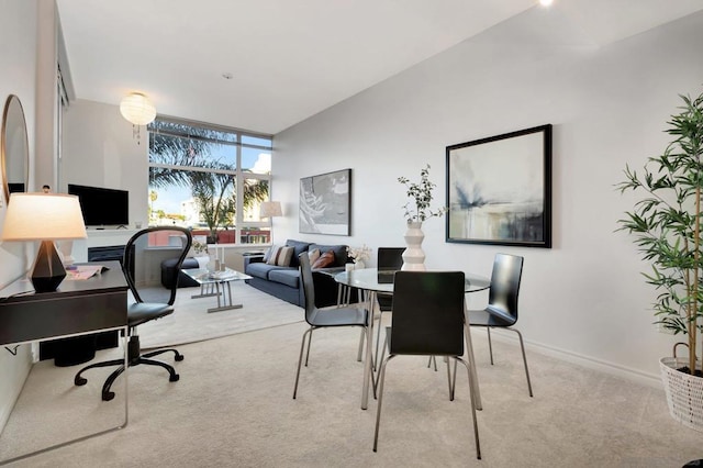 home office with floor to ceiling windows and light carpet