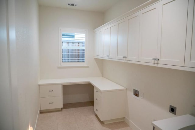 washroom with washer hookup, cabinets, electric dryer hookup, and light tile patterned flooring