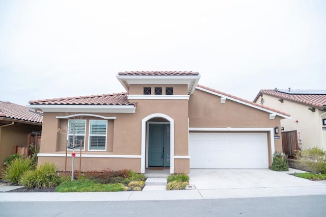 mediterranean / spanish-style house with a garage