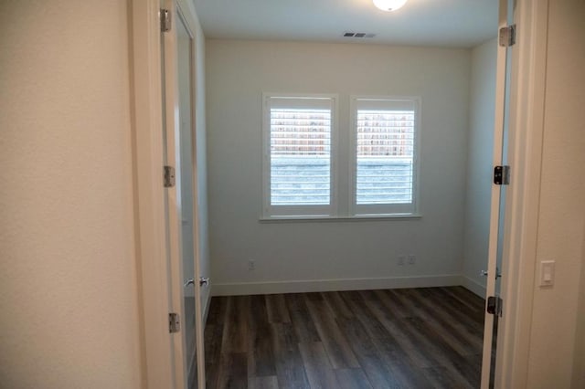 unfurnished bedroom with dark hardwood / wood-style floors