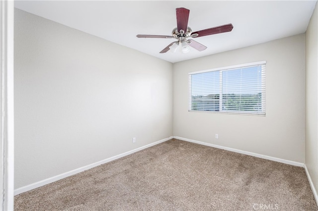 unfurnished room with ceiling fan and carpet