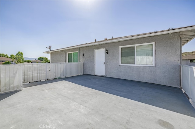 rear view of property featuring a patio