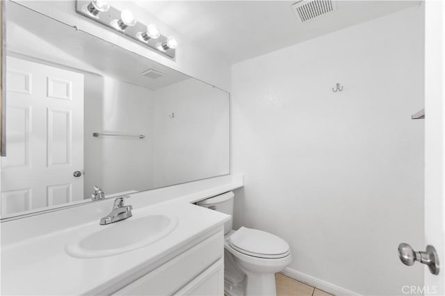 bathroom featuring toilet, tile patterned flooring, and vanity