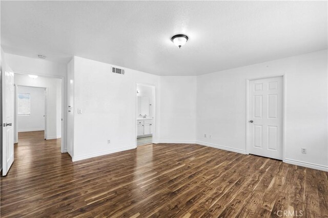 spare room featuring dark hardwood / wood-style flooring