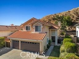 mediterranean / spanish home featuring a garage