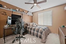 bedroom featuring ceiling fan and light colored carpet