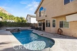 view of swimming pool with an in ground hot tub and a patio area