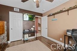 office with ceiling fan and dark hardwood / wood-style floors