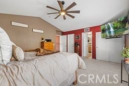 carpeted bedroom with ceiling fan and vaulted ceiling