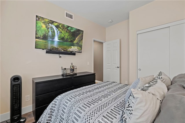 bedroom with a closet and hardwood / wood-style flooring