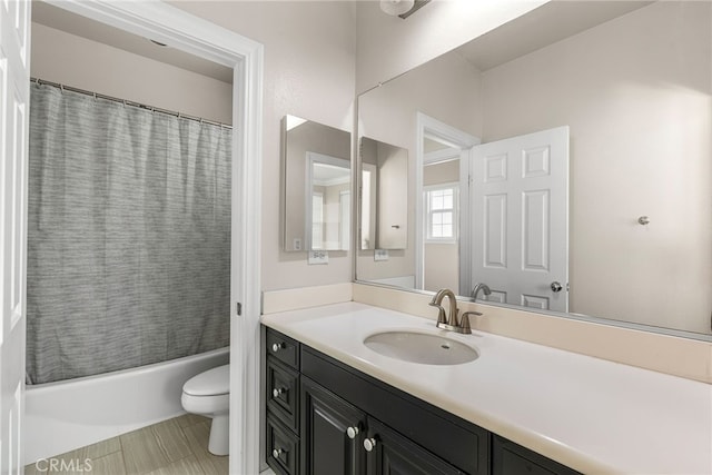 full bathroom featuring toilet, vanity, and shower / tub combo