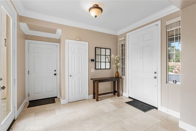 entryway with light tile patterned flooring and ornamental molding