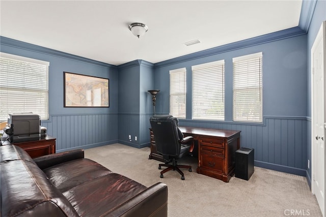 carpeted home office featuring crown molding