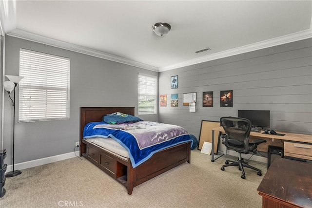 carpeted bedroom with wood walls and crown molding