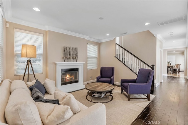 living room featuring hardwood / wood-style flooring and crown molding