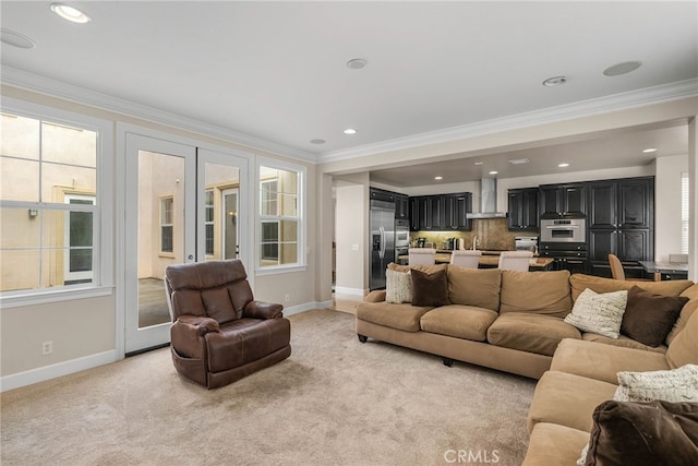 carpeted living room with ornamental molding and a healthy amount of sunlight