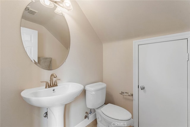 bathroom featuring toilet and vaulted ceiling