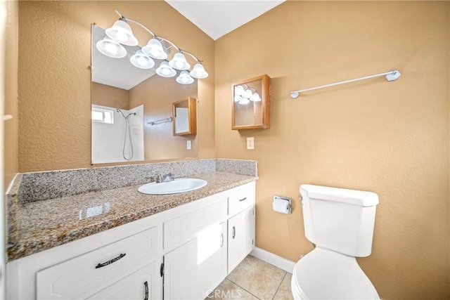 bathroom featuring toilet, vanity, and tile patterned flooring