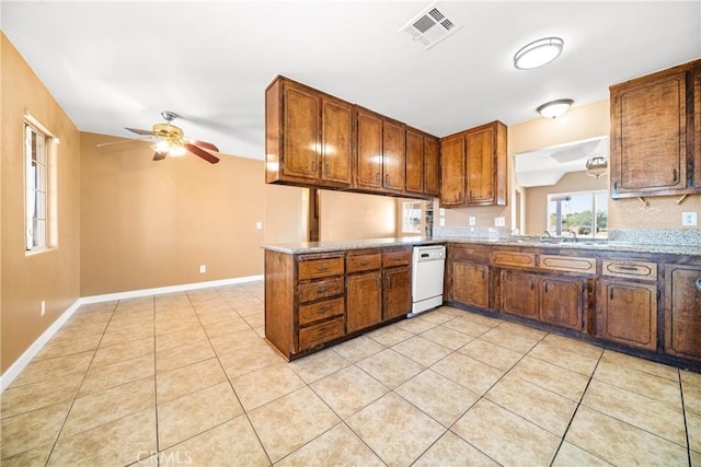 kitchen featuring ceiling fan, light tile patterned floors, white dishwasher, and kitchen peninsula