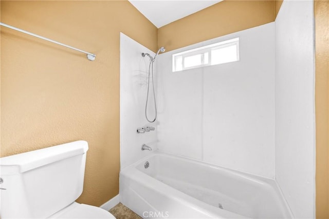 bathroom featuring toilet and bathing tub / shower combination