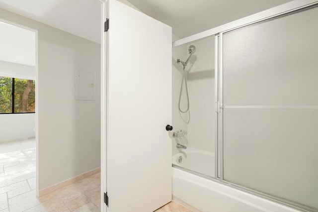 bathroom featuring tile patterned floors and shower / bath combination with glass door