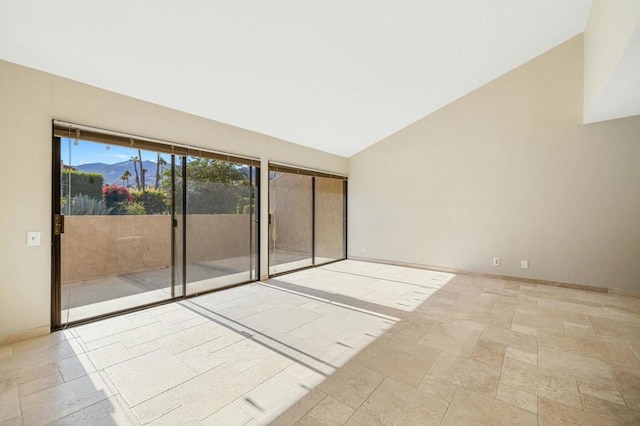 unfurnished room featuring lofted ceiling