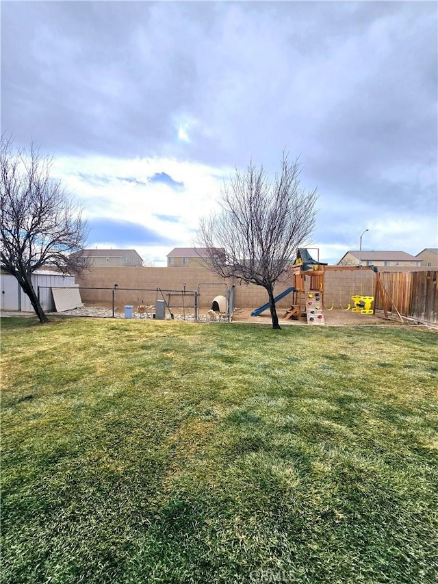 view of yard featuring a playground and a fenced backyard