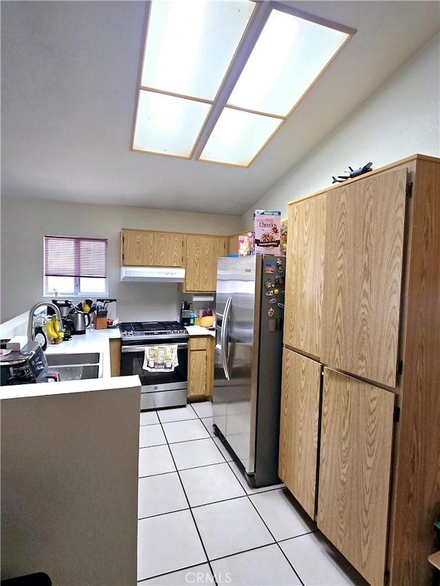 kitchen featuring light tile patterned floors, appliances with stainless steel finishes, sink, and vaulted ceiling