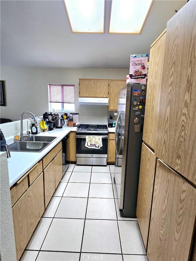 kitchen featuring light tile patterned floors, stainless steel appliances, and sink