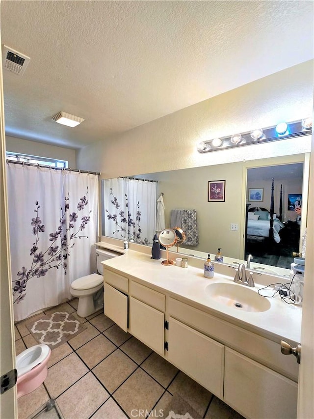 bathroom with visible vents, toilet, tile patterned flooring, a textured ceiling, and vanity