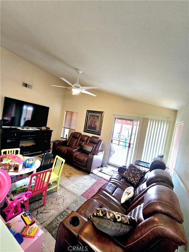 living room with ceiling fan, lofted ceiling, and carpet floors