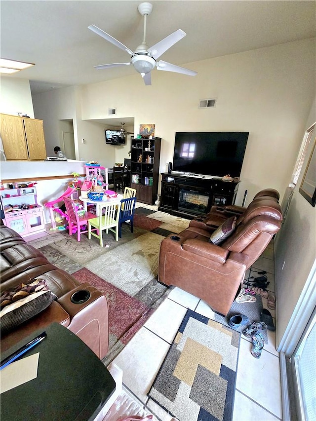 living room featuring ceiling fan and light tile patterned floors