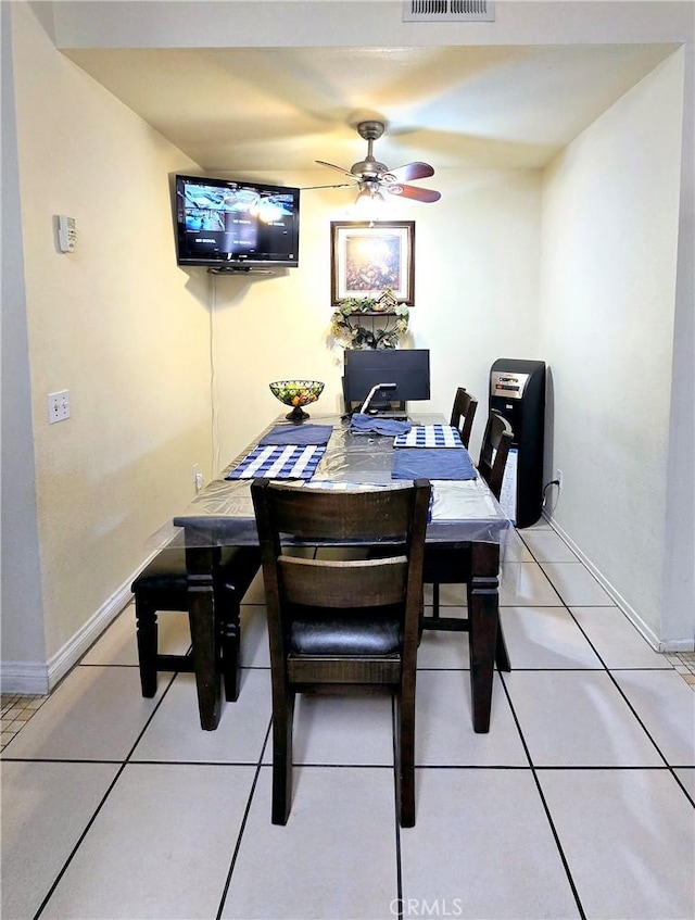 tiled dining area with ceiling fan