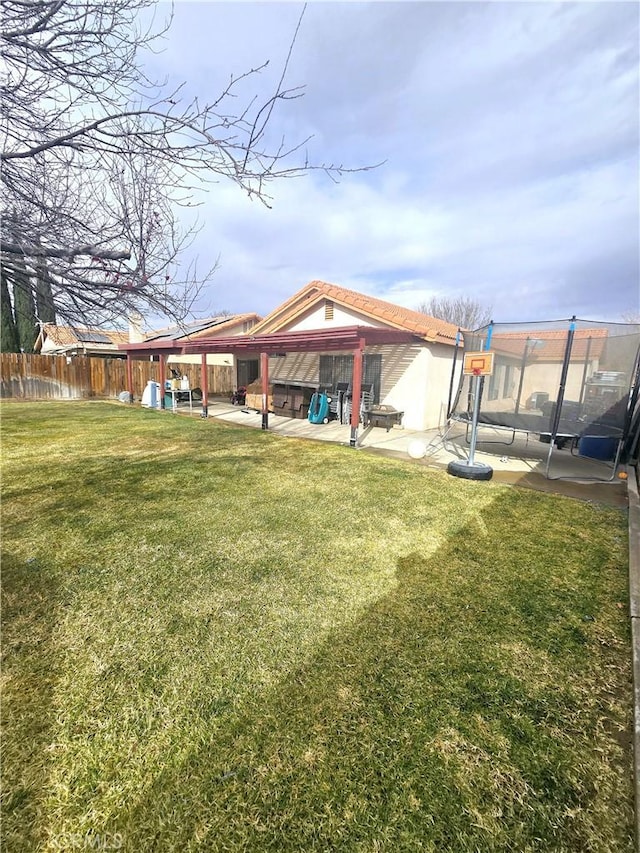 view of yard featuring fence and a patio