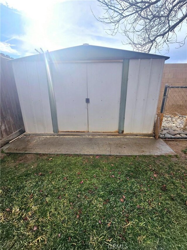 view of outbuilding featuring a lawn