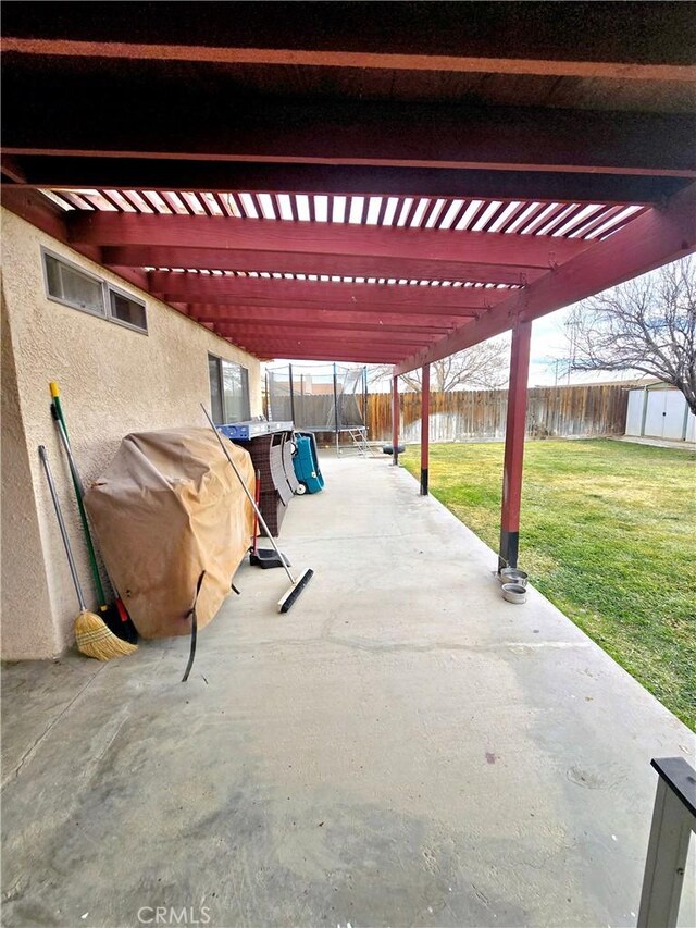 view of patio / terrace featuring a shed, a pergola, grilling area, and a trampoline