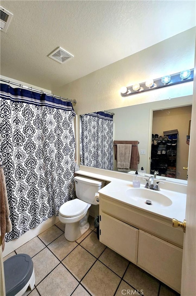 bathroom with toilet, tile patterned flooring, and visible vents