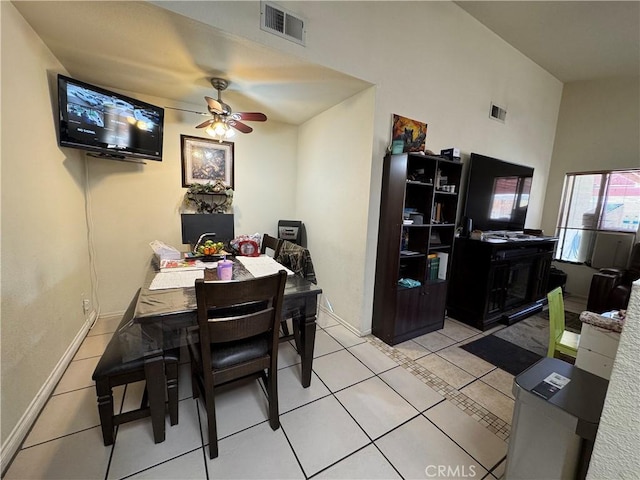 tiled dining space with a ceiling fan, visible vents, and baseboards