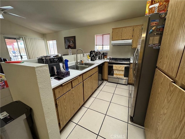 kitchen featuring appliances with stainless steel finishes, light tile patterned flooring, a sink, a peninsula, and under cabinet range hood