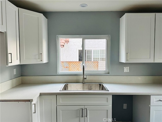 kitchen featuring sink and white cabinetry