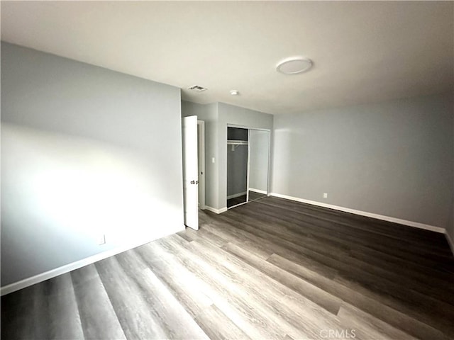 unfurnished bedroom with a closet and light hardwood / wood-style floors