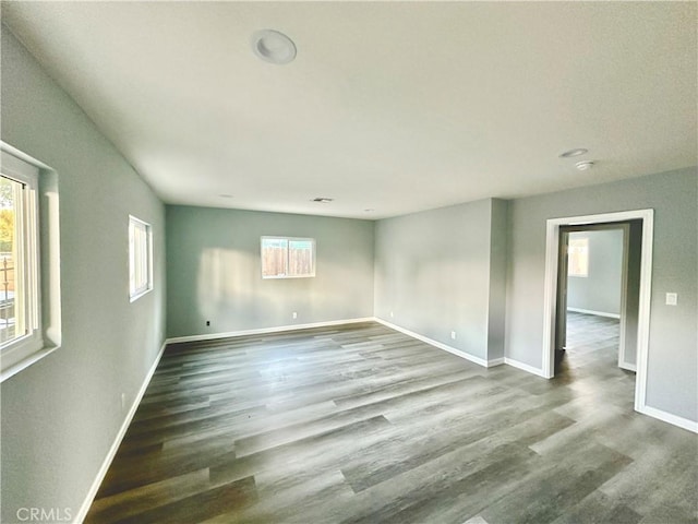 empty room with dark wood-type flooring