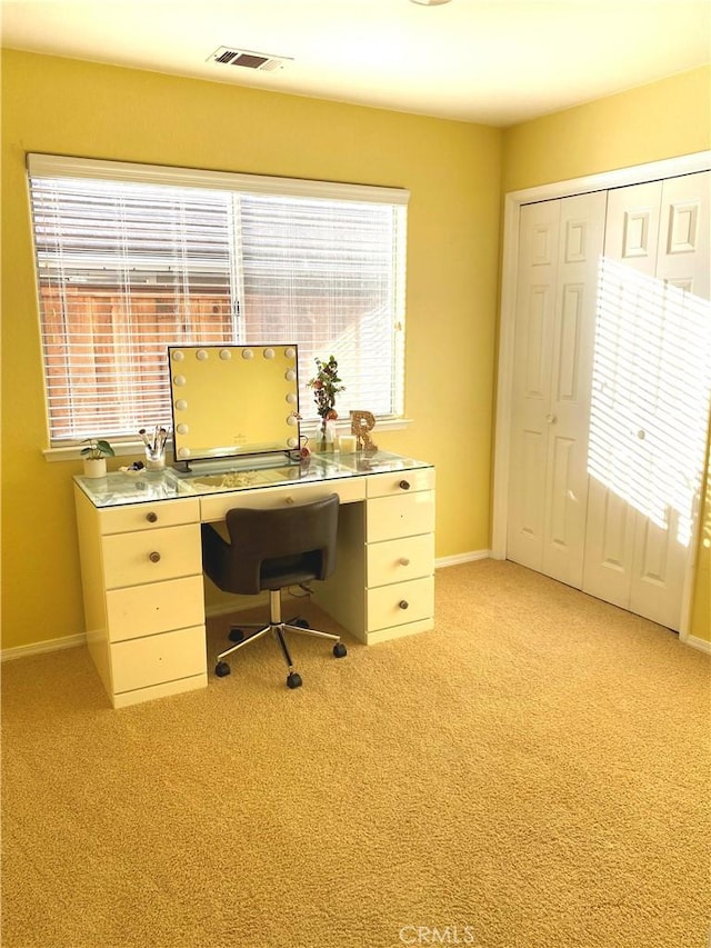 home office featuring light carpet and a healthy amount of sunlight