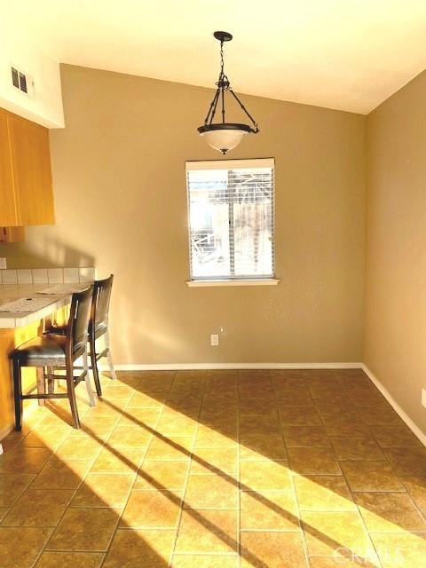 dining area featuring dark tile patterned flooring