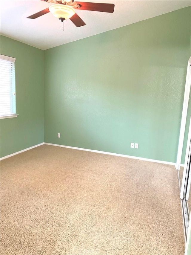 carpeted empty room with ceiling fan