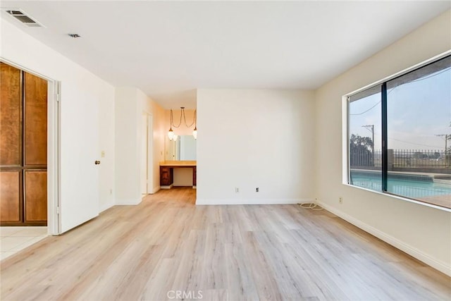 empty room with light hardwood / wood-style flooring