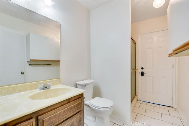 bathroom with toilet, walk in shower, vanity, and tile patterned flooring