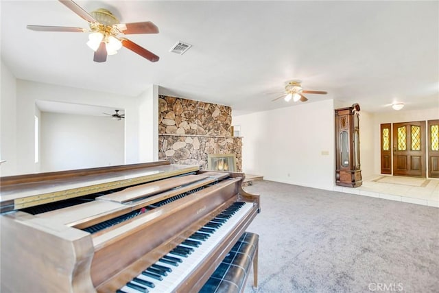 miscellaneous room featuring light carpet and a fireplace