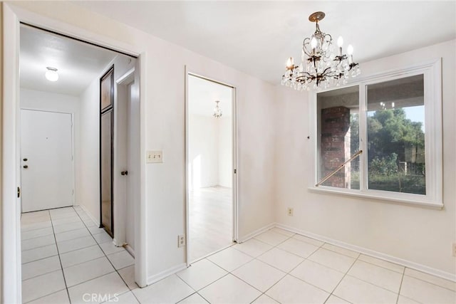 unfurnished dining area with light tile patterned flooring and a notable chandelier