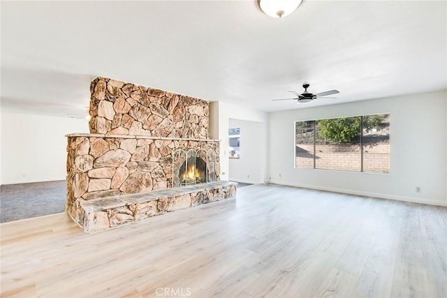 unfurnished living room featuring ceiling fan, hardwood / wood-style floors, and a fireplace